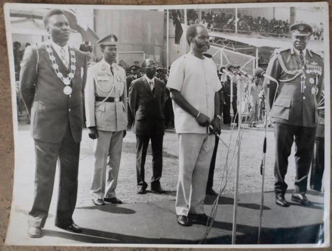 'H.E. President Lt. Gen. M. Micombero addresses the Public in Nakivubo Stadium on the 3rd Anniversary of the Second Republic. On his left is H.E. President Gen. Idi Amin of Uganda and on his right is H.E. Maj. Gen. Habyalimana president of Ruanda'. Habyarimana's death still remains a mystery..